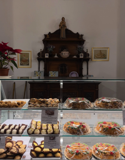 A Palermo pasticceria counter lined with Sicilian pastries and cakes